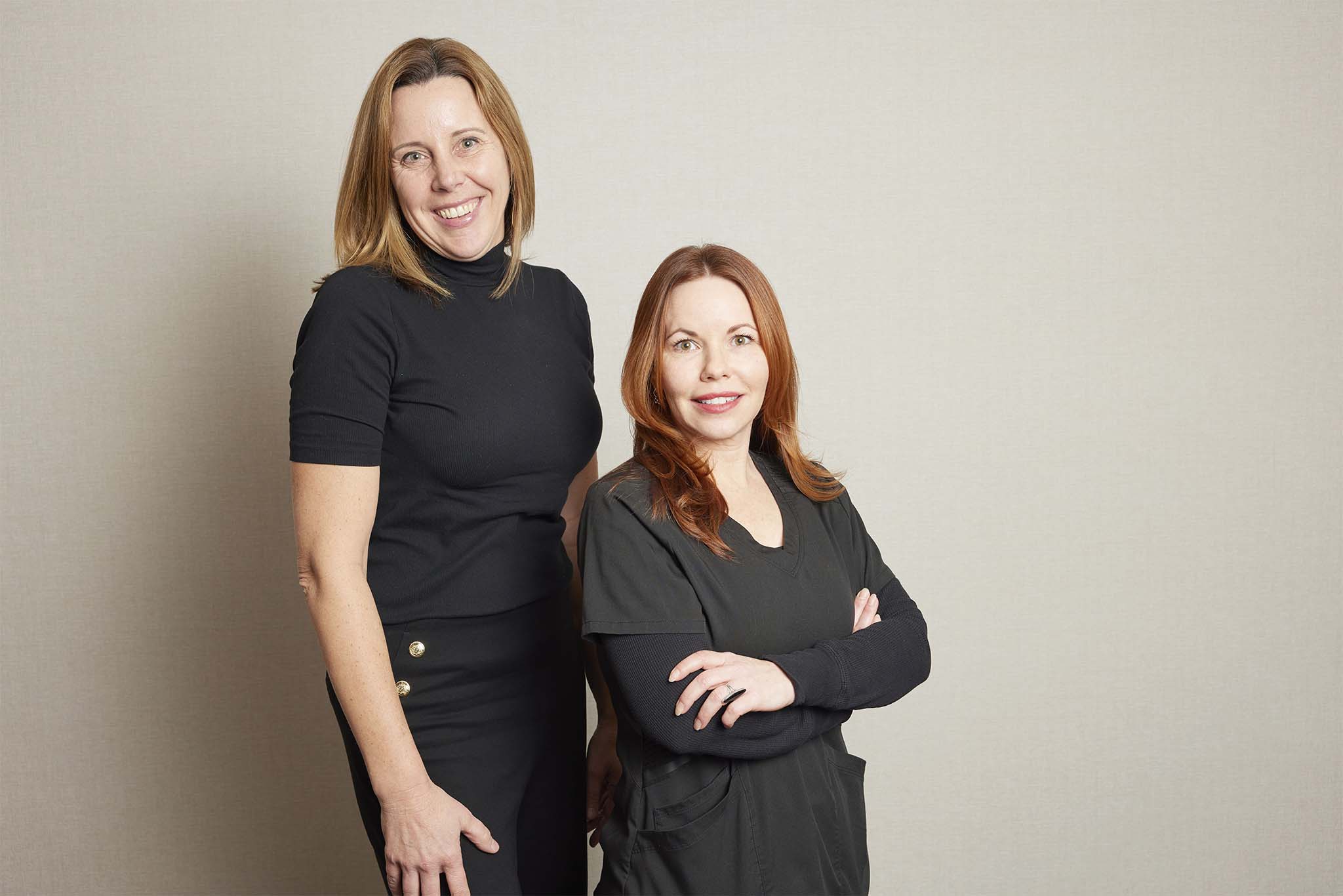 Managerial staff at Grosse Pointe Dermatology & Cosmetic Center, two smiling female team members in professional attire.